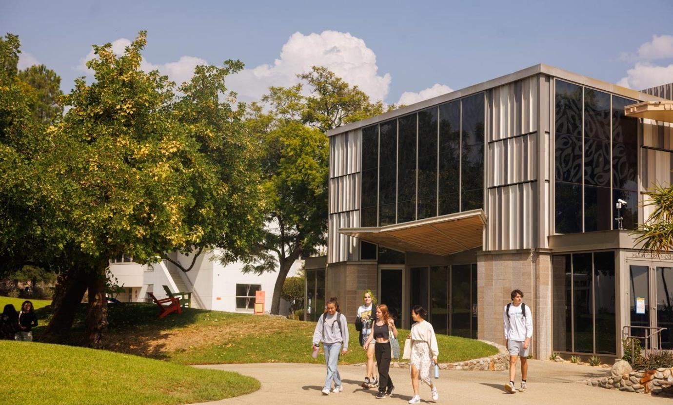 Students walk past the exterior of Benson Auditorium.